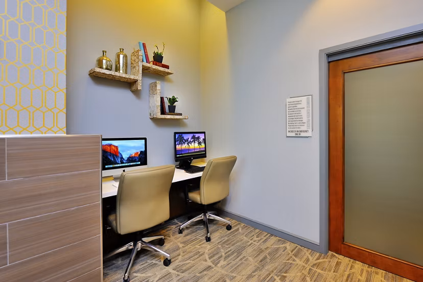 Business center with modern decor at The Townhomes at Woodmill Creek luxury apartments