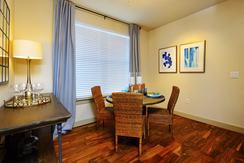 Dining area featuring modern furniture and elegant lighting at The Townhomes at Woodmill Creek apartments