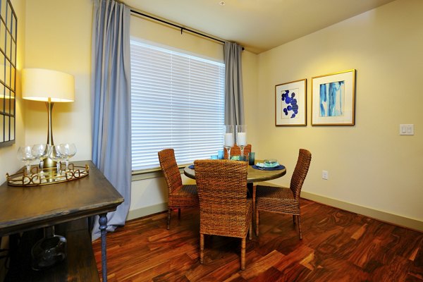 Dining area featuring modern furniture and elegant lighting at The Townhomes at Woodmill Creek apartments