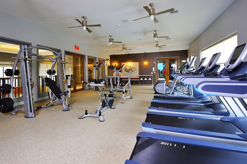 Fitness center featuring modern exercise equipment at The Townhomes at Woodmill Creek luxury apartments