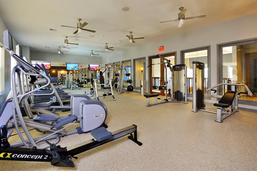 Modern fitness room with state-of-the-art equipment at The Townhomes at Woodmill Creek