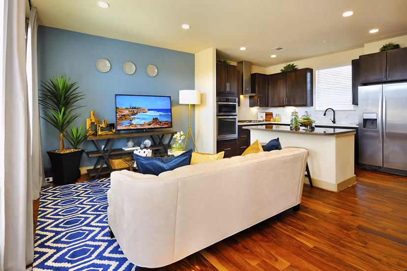 Spacious living room with elegant decor in The Townhomes at Woodmill Creek, luxury apartments