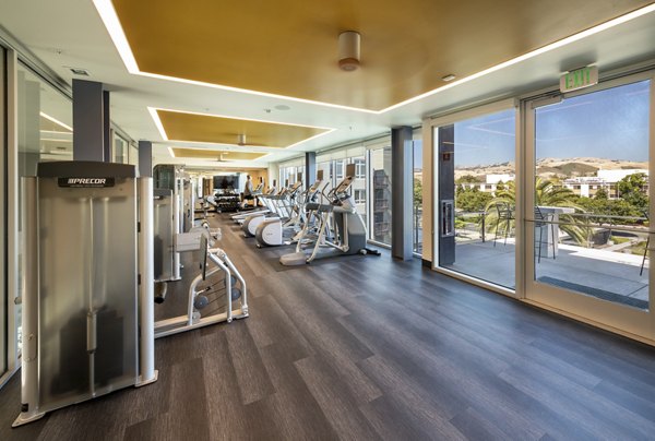 Fitness room with modern exercise equipment at VIO apartments