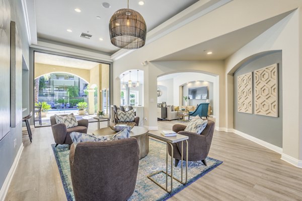 Modern clubhouse featuring elegant seating and large windows at Stone Canyon Apartments