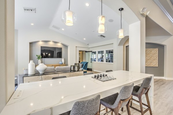 Clubhouse with modern design and cozy seating at Stone Canyon Apartments, a luxury living community