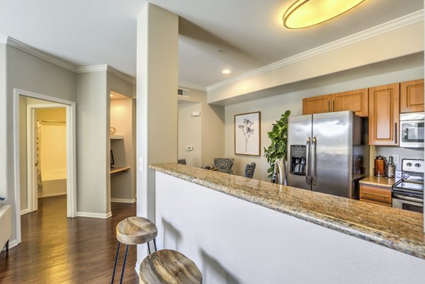 Modern kitchen featuring stainless steel appliances at Stone Canyon Apartments