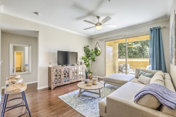 Spacious living room with modern furnishings and neutral tones in Stone Canyon Apartments