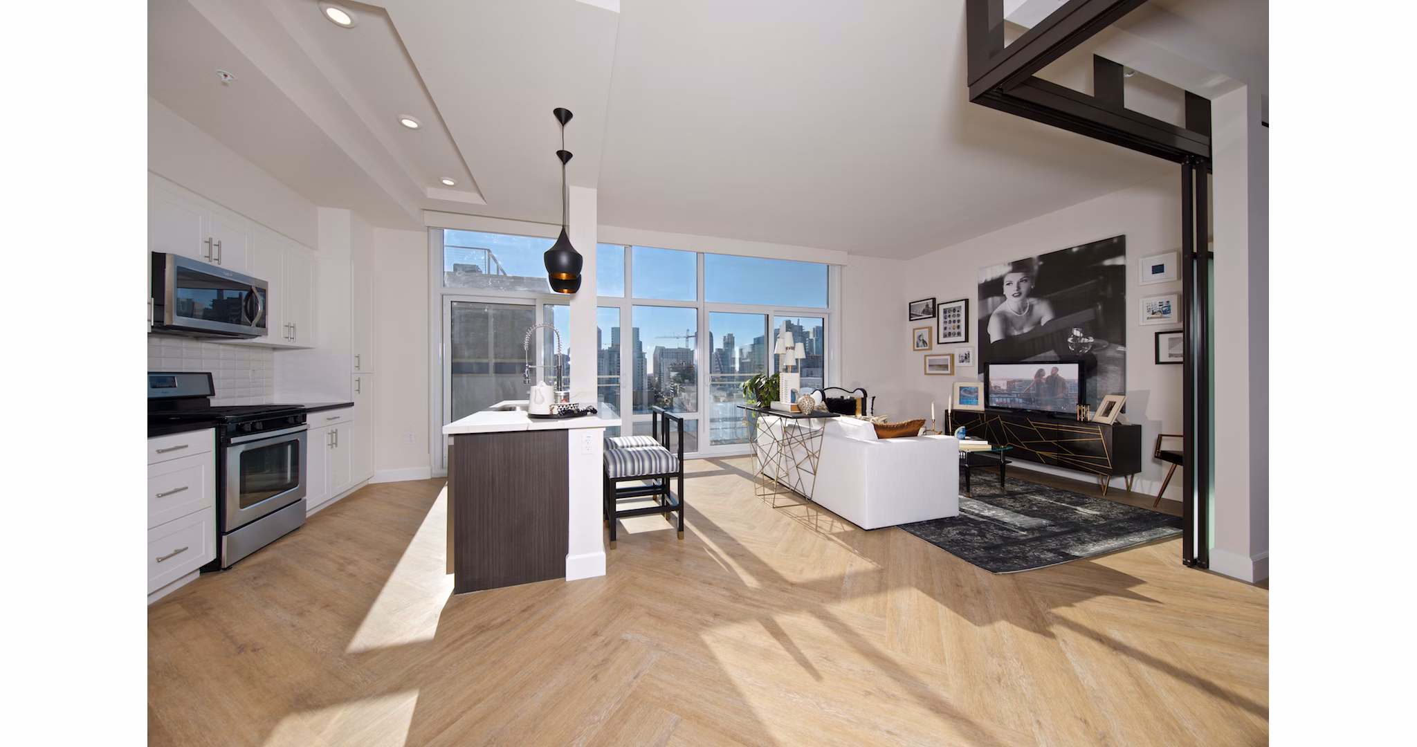Modern kitchen with stainless steel appliances in Eighteen Ten State St Apartments, offering luxury living spaces