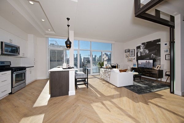 Modern kitchen with stainless steel appliances in Eighteen Ten State St Apartments, offering luxury living spaces
