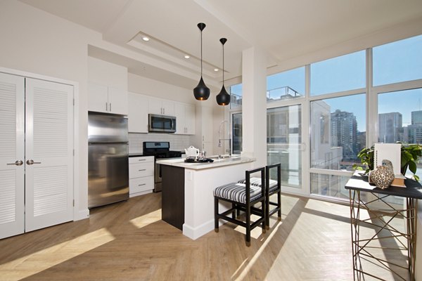 Modern kitchen with stainless steel appliances at Eighteen Ten State St Apartments, offering a luxury living experience