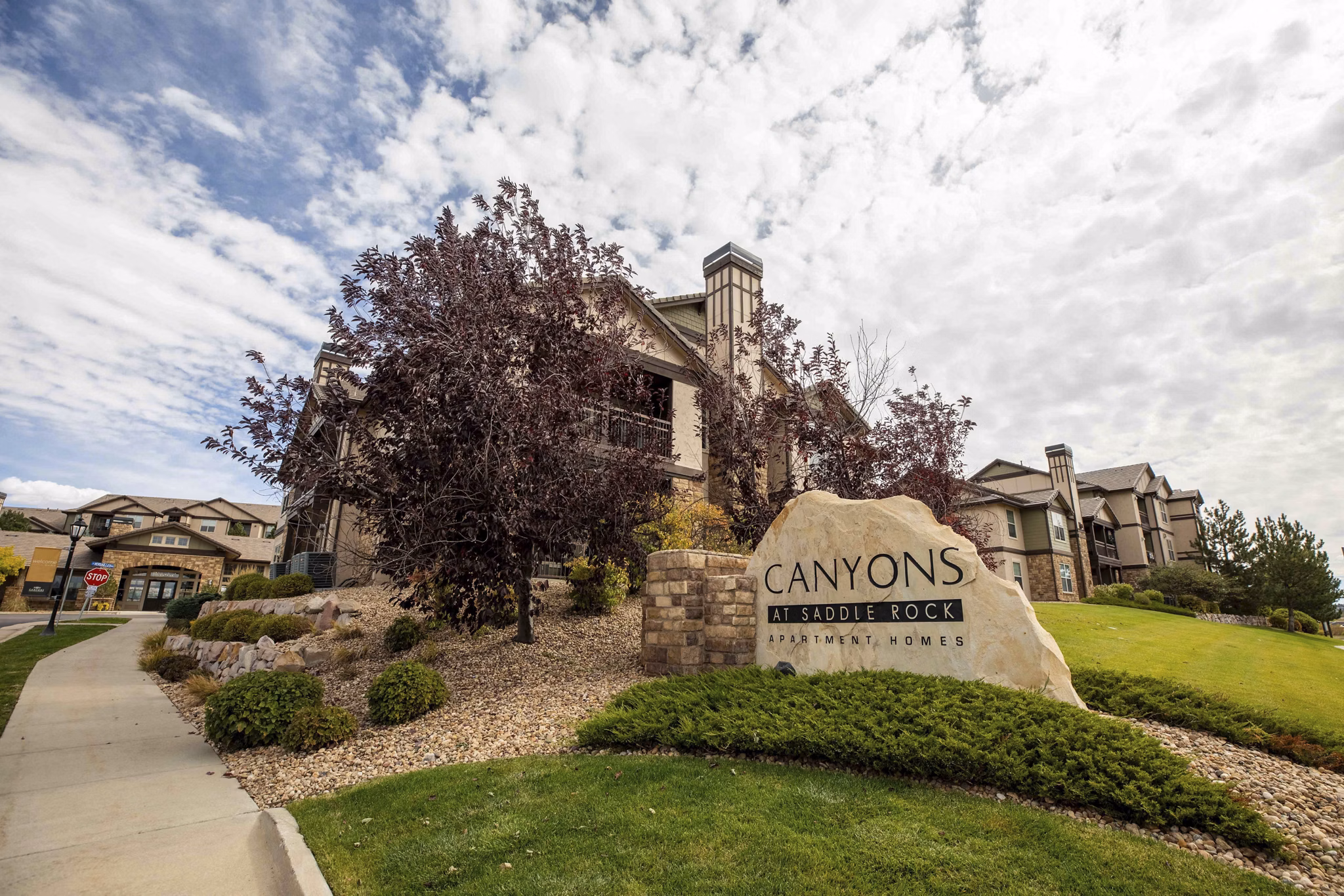 Canyons at Saddle Rock Apartments: Elegant building with prominent signage
