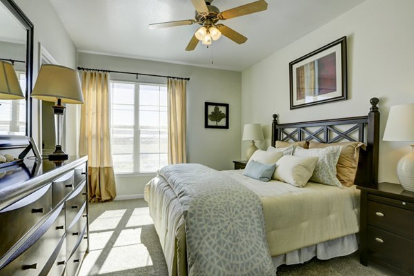 Bedroom featuring modern design and natural light at Canyons at Saddle Rock Apartments
