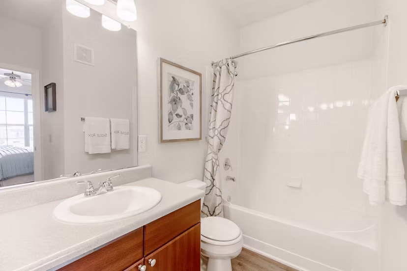 Bathroom featuring modern fixtures and marble countertops in Canyons at Saddle Rock Apartments