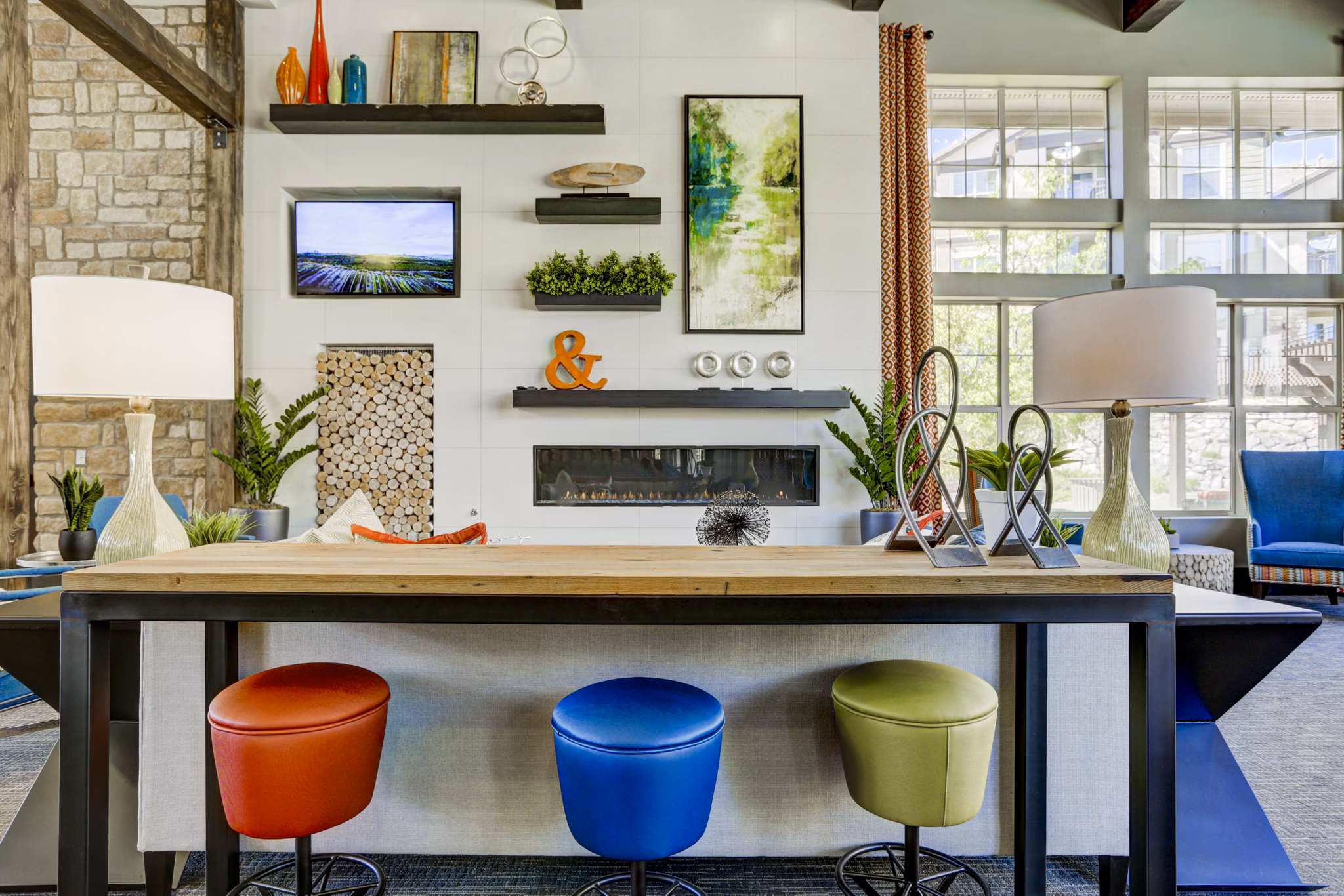 Clubhouse featuring modern interiors and seating areas at Canyons at Saddle Rock Apartments
