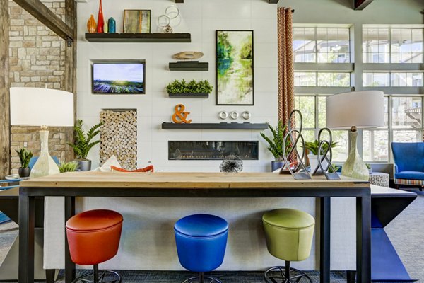 Clubhouse featuring modern interiors and seating areas at Canyons at Saddle Rock Apartments