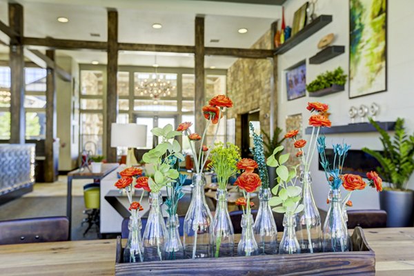 Canyons at Saddle Rock Apartments: Modern clubhouse with inviting seating areas and natural light in Aurora