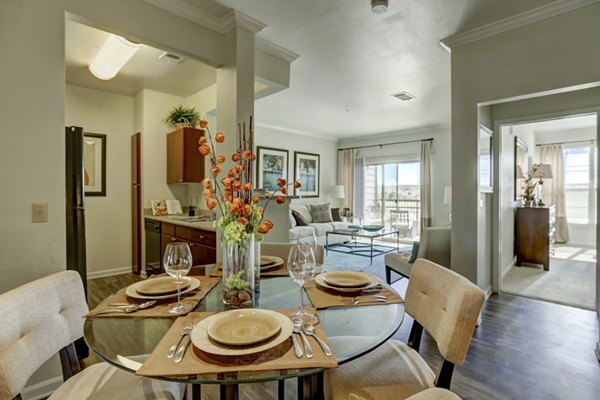 Dining area with modern decor at Canyons at Saddle Rock Apartments, featuring elegant furnishings and ample natural light
