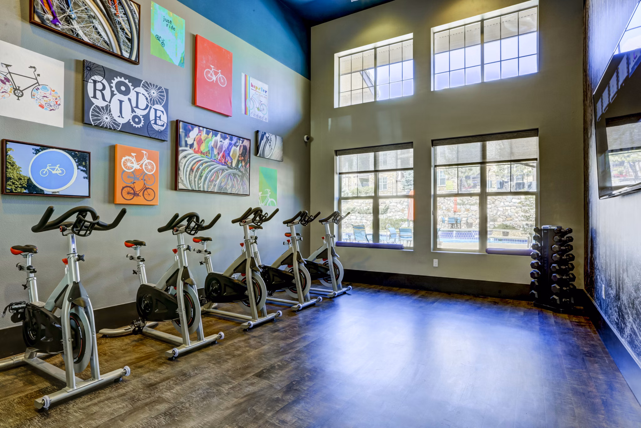 Modern yoga/spin studio with natural light at Canyons at Saddle Rock Apartments, perfect for fitness enthusiasts seeking luxury living
