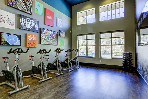 Modern yoga/spin studio with natural light at Canyons at Saddle Rock Apartments, perfect for fitness enthusiasts seeking luxury living