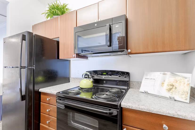 Modern kitchen with stainless steel appliances at Canyons at Saddle Rock Apartments
