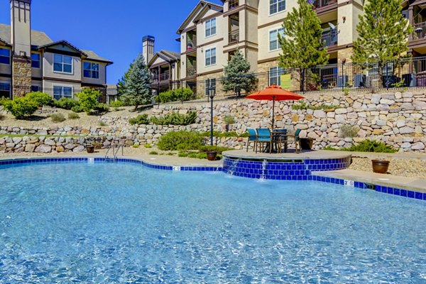 Resort-style outdoor pool at Canyons at Saddle Rock Apartments offering luxury relaxation spaces for residents