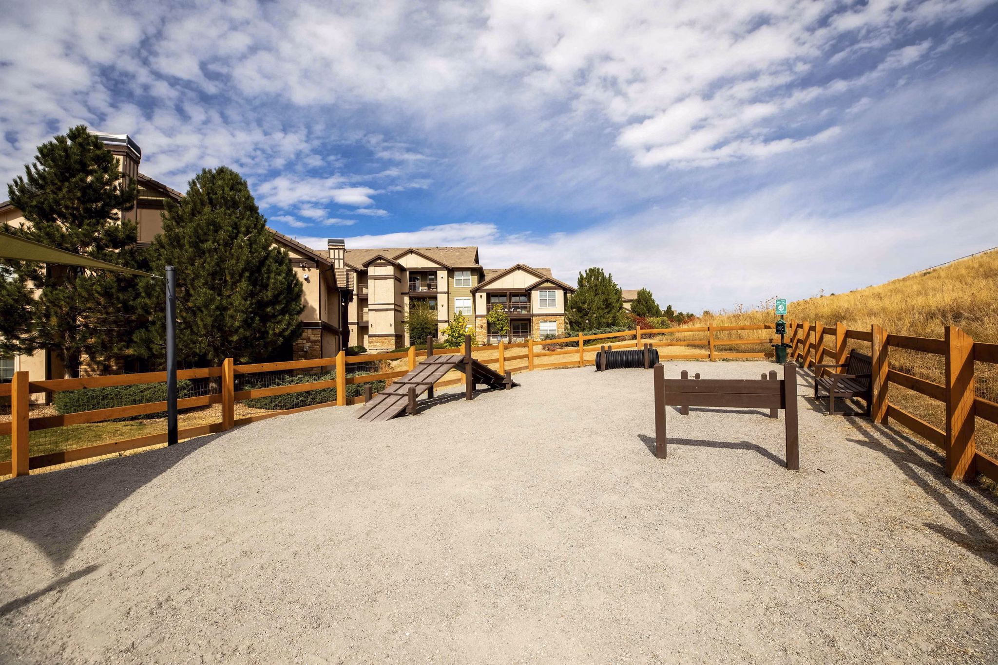 Dog park with agility equipment at Canyons at Saddle Rock Apartments
