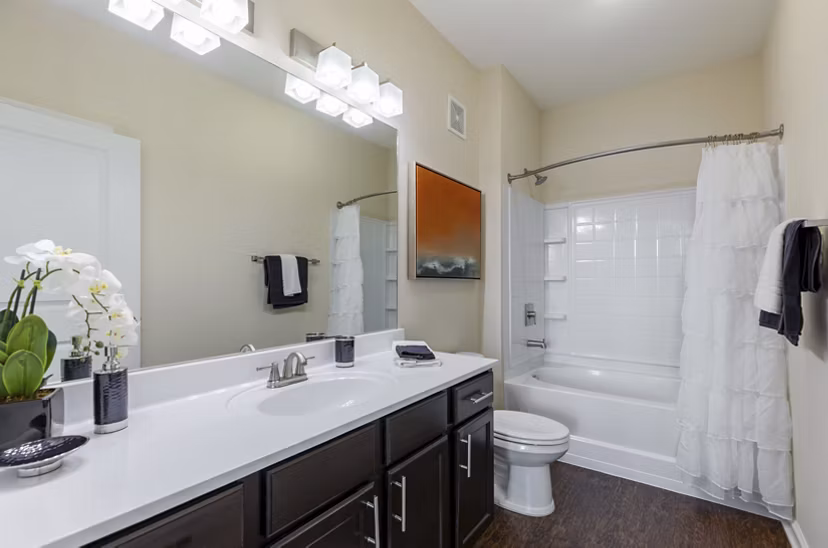 Bathroom featuring sleek fixtures and stylish tile design at Waterford at Southlands Apartments