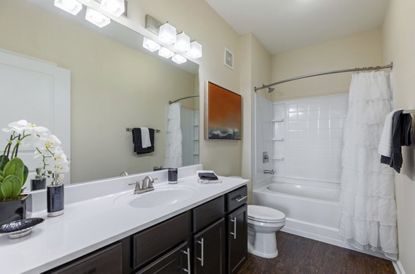 Bathroom featuring sleek fixtures and stylish tile design at Waterford at Southlands Apartments