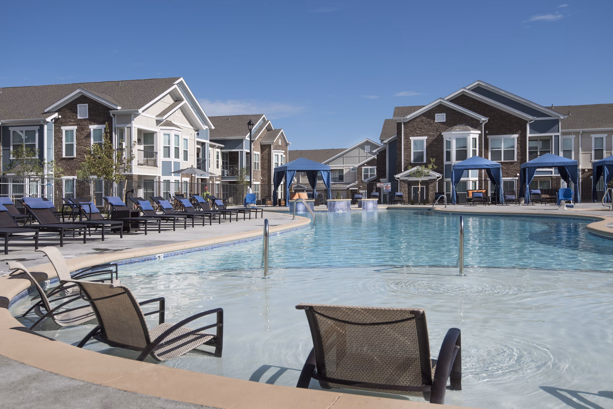 Resort-style pool with lounge chairs at Waterford at Southlands Apartments, ideal for relaxation and leisure activities