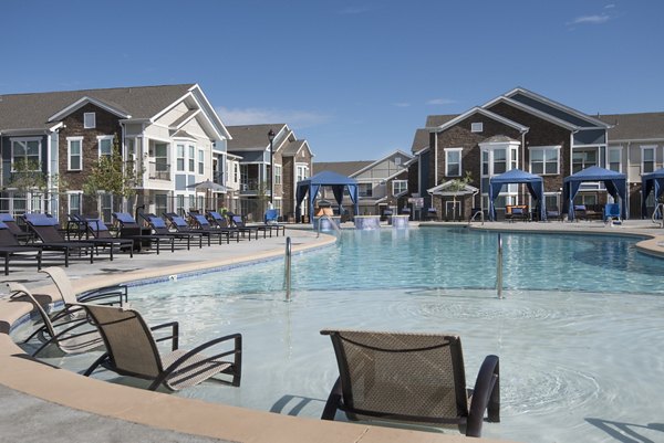 Resort-style pool with lounge chairs at Waterford at Southlands Apartments, ideal for relaxation and leisure activities