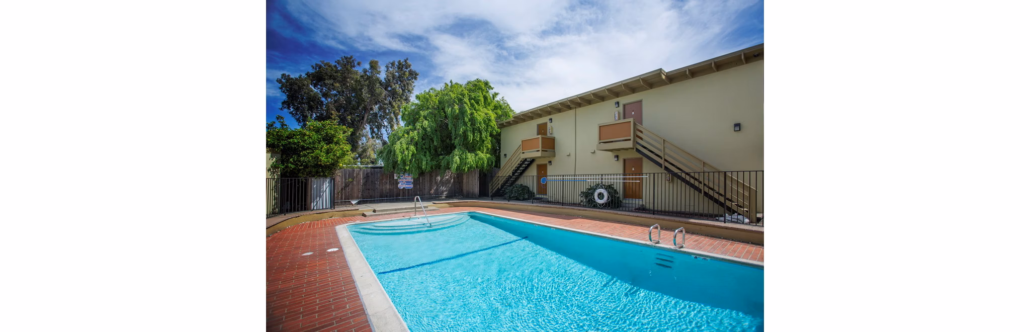 Outdoor pool with spacious deck at Woodland Park Apartments, luxury living with resort-style amenities