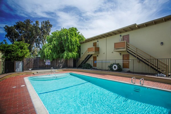 Outdoor pool with spacious deck at Woodland Park Apartments, luxury living with resort-style amenities