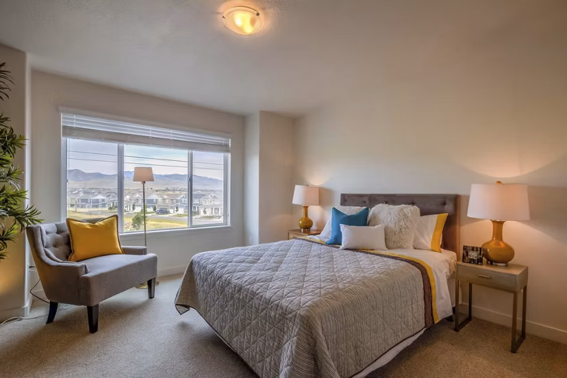 Bedroom with modern decor and natural light at Rockwell Village Apartments