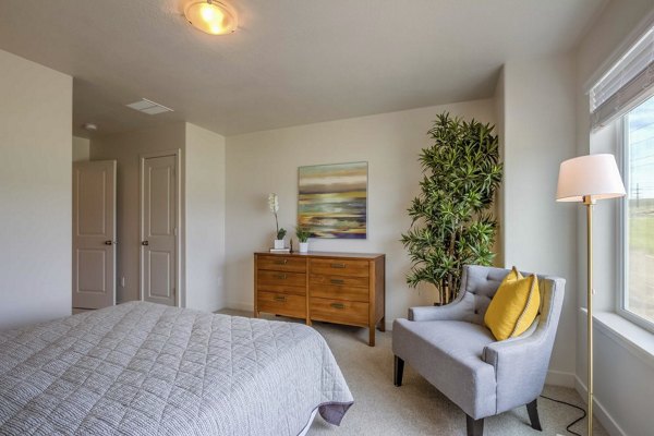 Bedroom featuring modern design elements at Rockwell Village Apartments