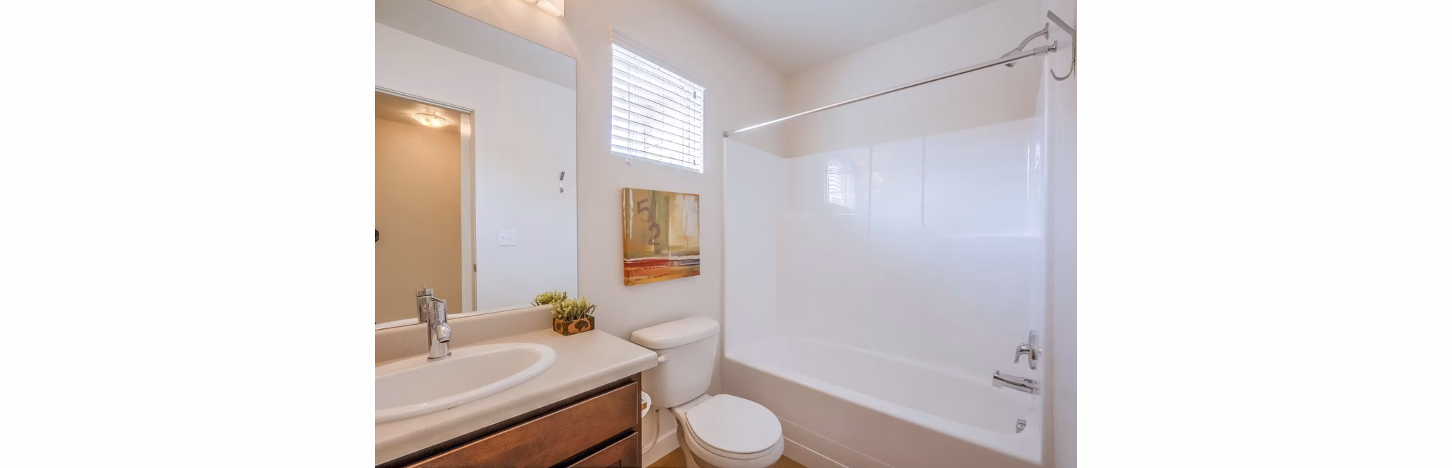 Spa-like bathroom with sleek fixtures at Rockwell Village Apartments, showcasing luxury design and high-end finishes