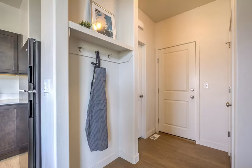 Hallway with modern lighting and hardwood floors in Rockwell Village Apartments