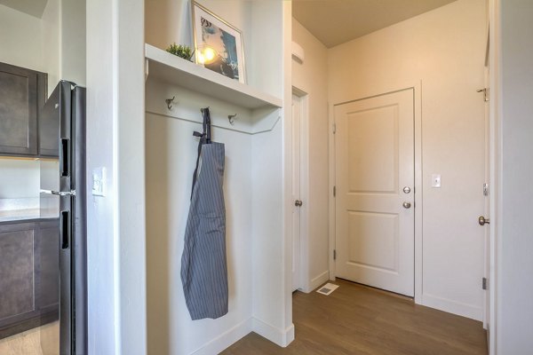 Hallway with modern lighting and hardwood floors in Rockwell Village Apartments