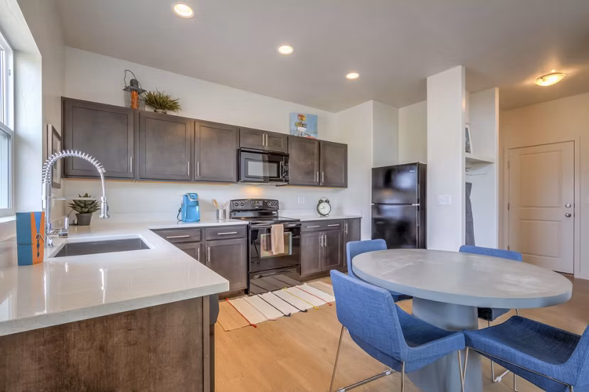 Modern kitchen with stainless steel appliances in Rockwell Village Apartments