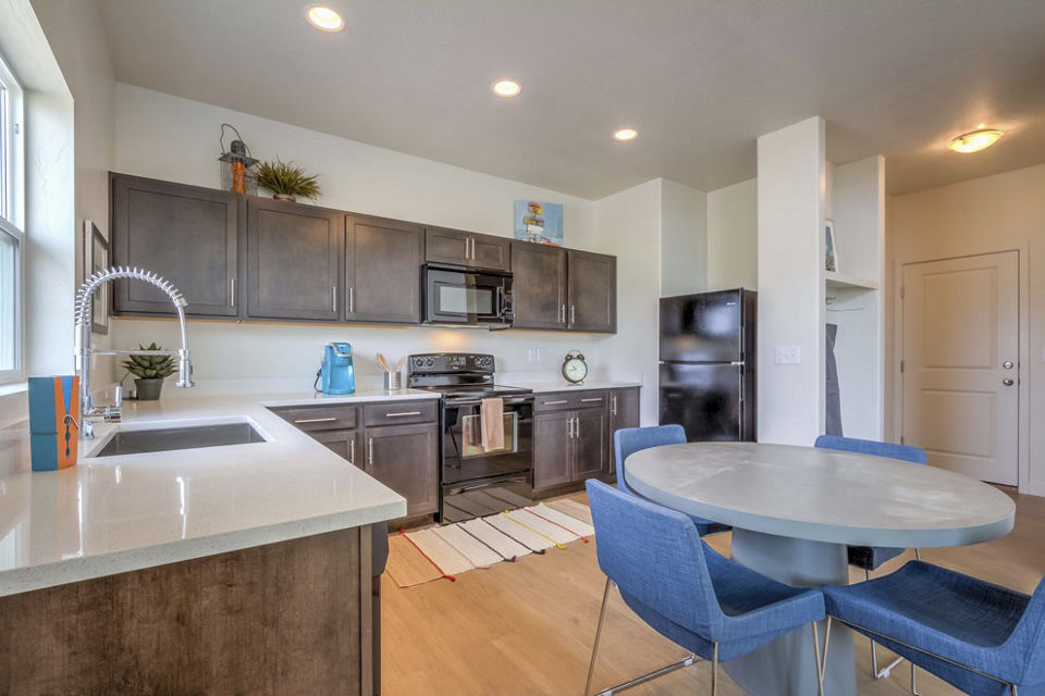 Modern kitchen with stainless steel appliances in Rockwell Village Apartments