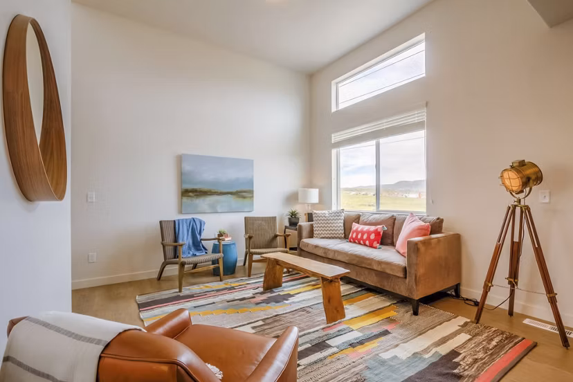 Contemporary living room with open layout at Rockwell Village Apartments featuring stylish decor and ample natural light