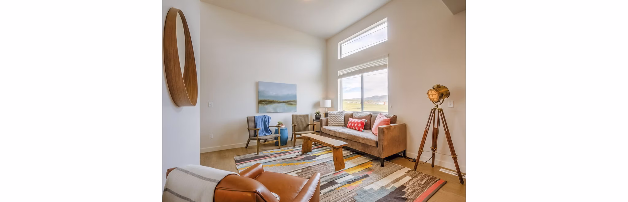 Contemporary living room with open layout at Rockwell Village Apartments featuring stylish decor and ample natural light