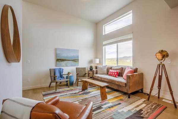 Contemporary living room with open layout at Rockwell Village Apartments featuring stylish decor and ample natural light