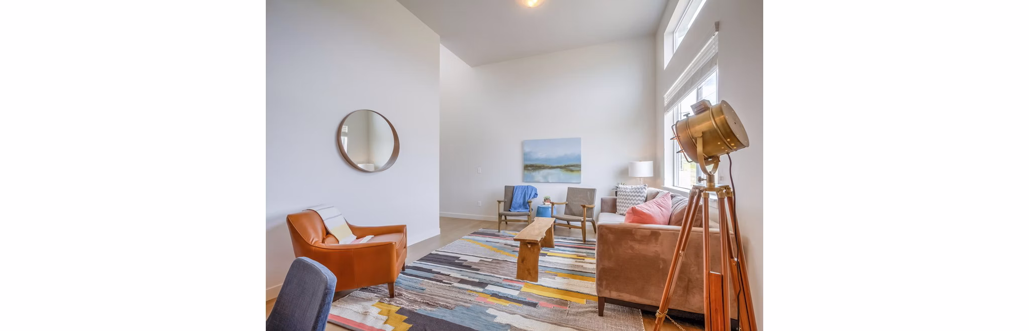 Spacious living room with modern furnishings at Rockwell Village Apartments