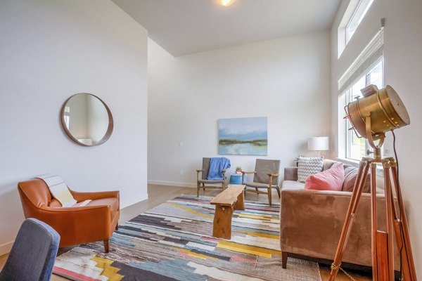 Spacious living room with modern furnishings at Rockwell Village Apartments