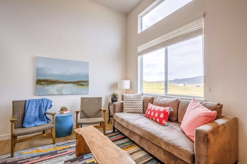 Spacious living room with modern furnishings at Rockwell Village Apartments