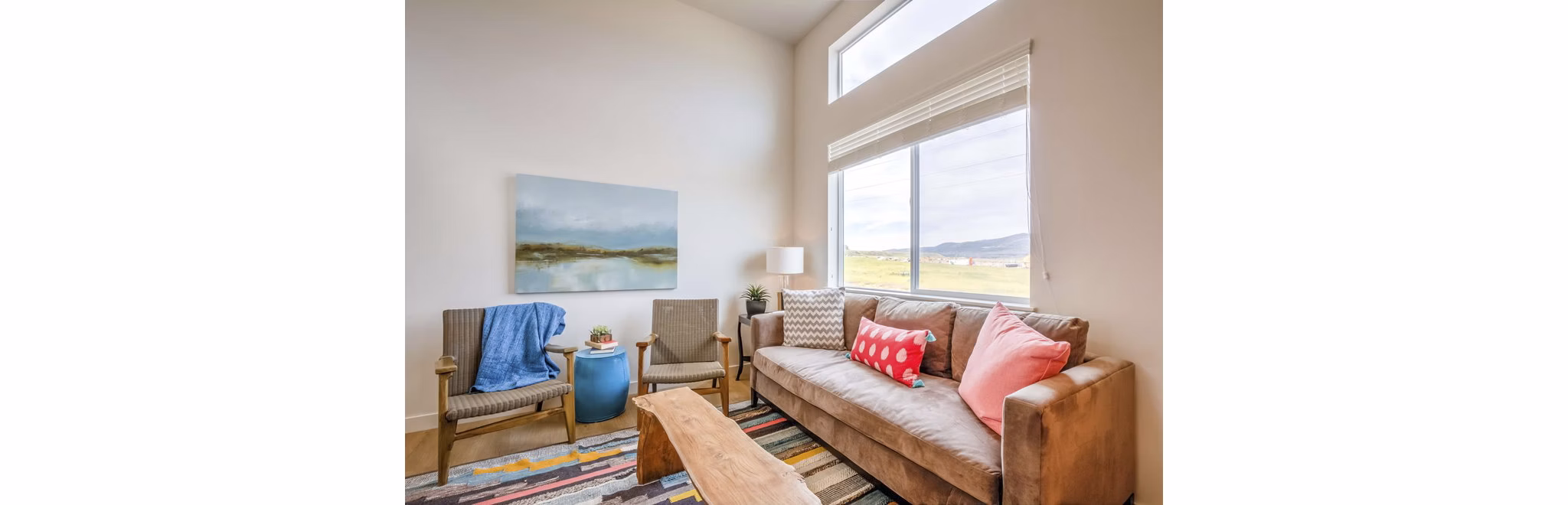 Spacious living room with modern furnishings at Rockwell Village Apartments