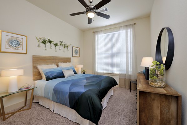 Cozy bedroom with stylish furnishings at Broadstone Woodmill Creek Apartments, featuring large windows and modern decor