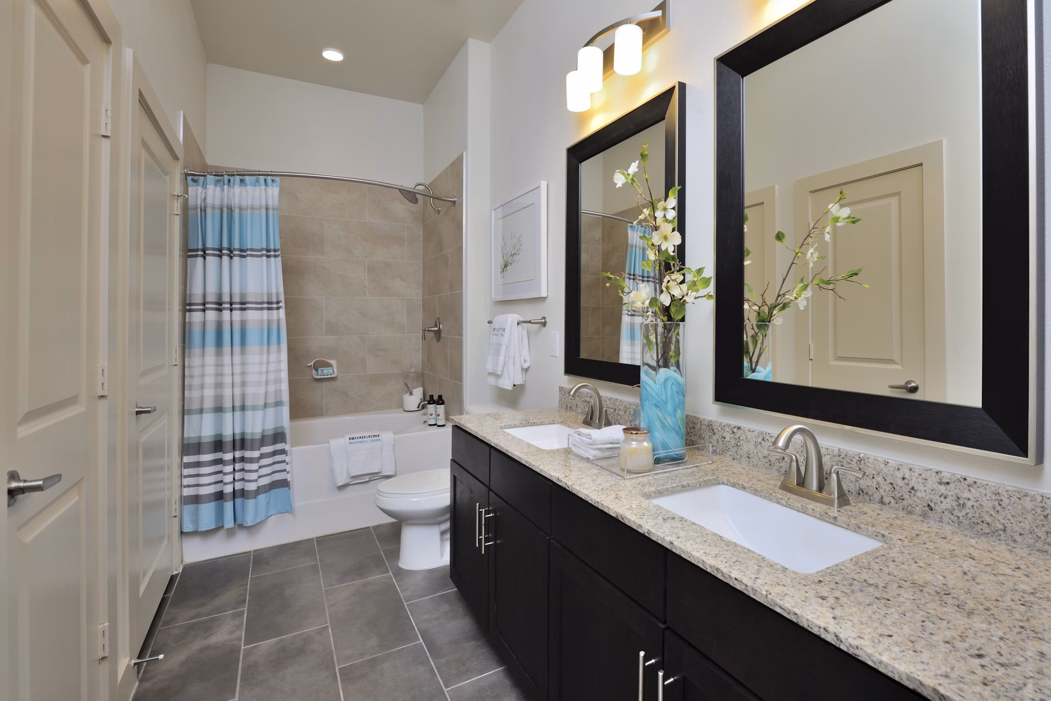 Modern bathroom with double vanity sinks at Broadstone Woodmill Creek Apartments