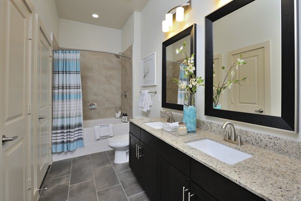 Modern bathroom with double vanity sinks at Broadstone Woodmill Creek Apartments