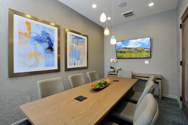 Meeting room with modern conference setup and bright lighting at Broadstone Woodmill Creek Apartments